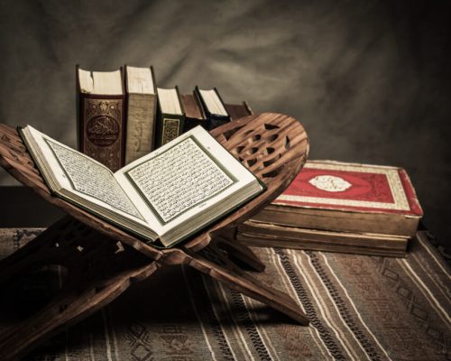 Koran - holy book of Muslims ( public item of all muslims ) on the table , still life .